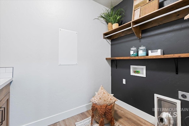 laundry room with hookup for a washing machine, hookup for an electric dryer, laundry area, baseboards, and light wood-type flooring