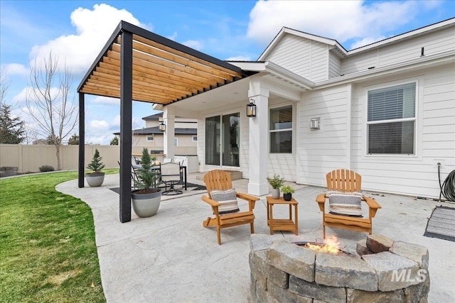 view of patio / terrace featuring a fire pit and fence