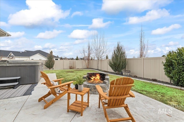 view of patio with a hot tub, a fire pit, and a fenced backyard