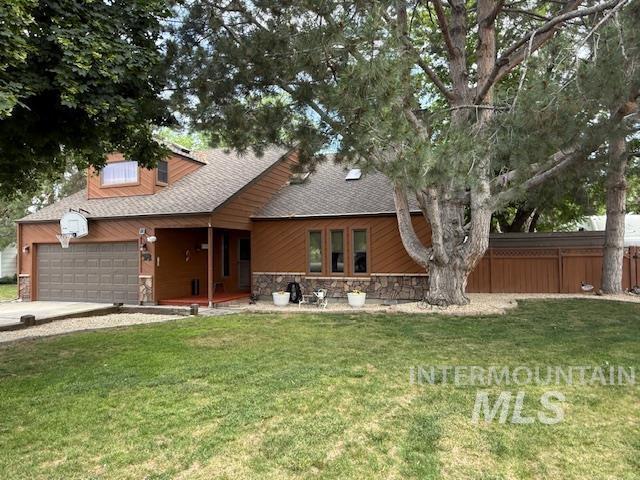 6812 View Ln, Nampa, ID 83687 - view of front of house featuring a garage, stone siding, concrete driveway, and roof with shingles
