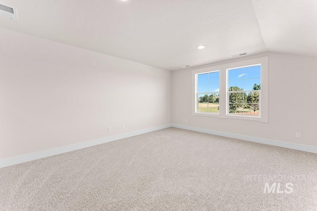 811 N Creekwater Lot 13/6, Eagle, ID 83616 - empty room with light carpet, vaulted ceiling, baseboards, and recessed lighting
