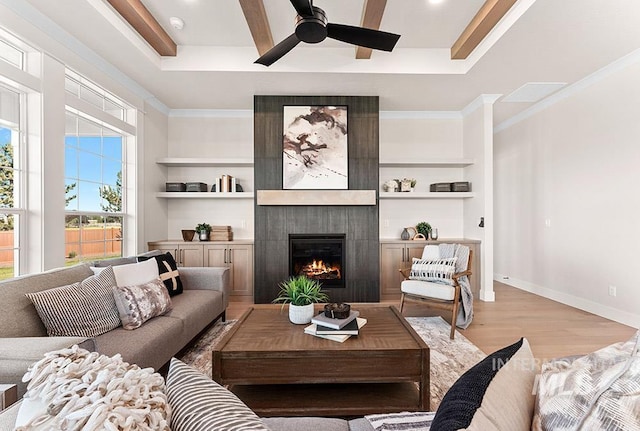 811 N Creekwater Lot 13/6, Eagle, ID 83616 - living area with a fireplace, a ceiling fan, light wood finished floors, a tray ceiling, and crown molding
