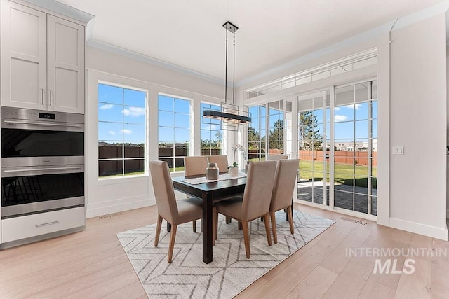 811 N Creekwater Lot 13/6, Eagle, ID 83616 - dining room with healthy amount of natural light, light wood-style floors, baseboards, and crown molding