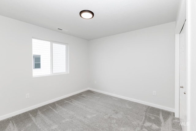 unfurnished bedroom featuring carpet, visible vents, and baseboards