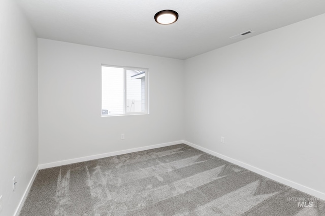 carpeted empty room with baseboards and visible vents