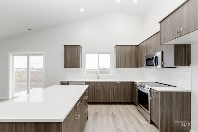 kitchen with visible vents, modern cabinets, appliances with stainless steel finishes, light countertops, and a sink