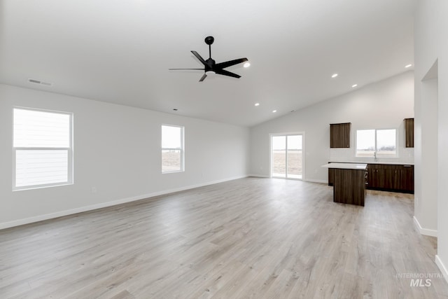 unfurnished living room with a healthy amount of sunlight, light wood-type flooring, and visible vents