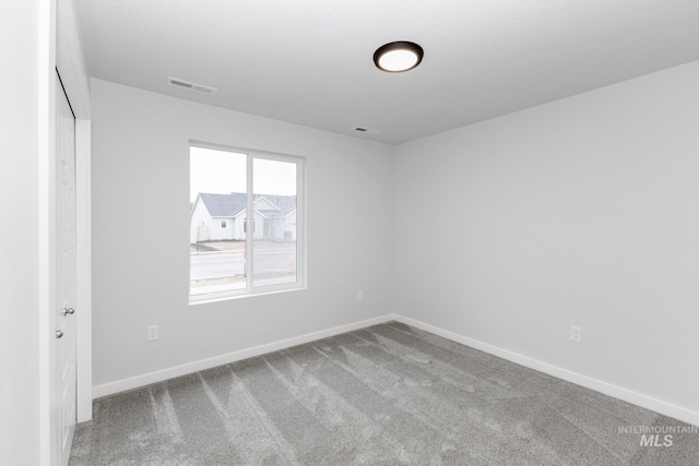 interior space with carpet floors, a closet, visible vents, and baseboards