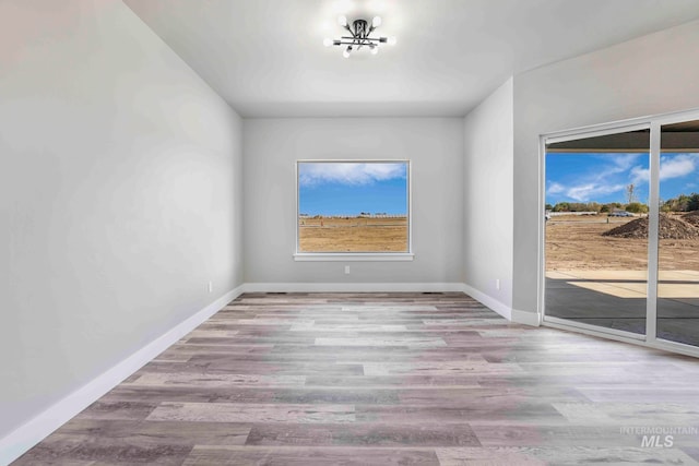 spare room with light hardwood / wood-style flooring