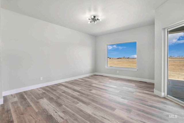 unfurnished room with light wood-type flooring