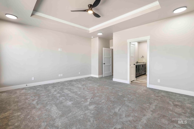 interior space featuring ceiling fan, a raised ceiling, and crown molding