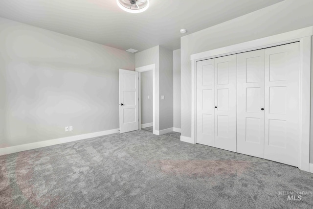 unfurnished bedroom with a closet and carpet flooring