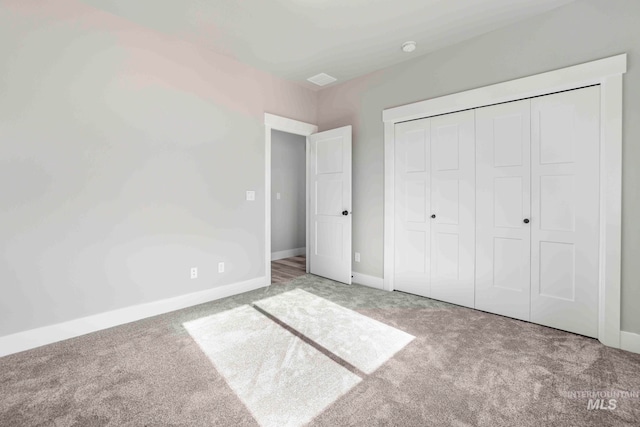 unfurnished bedroom featuring a closet and carpet floors