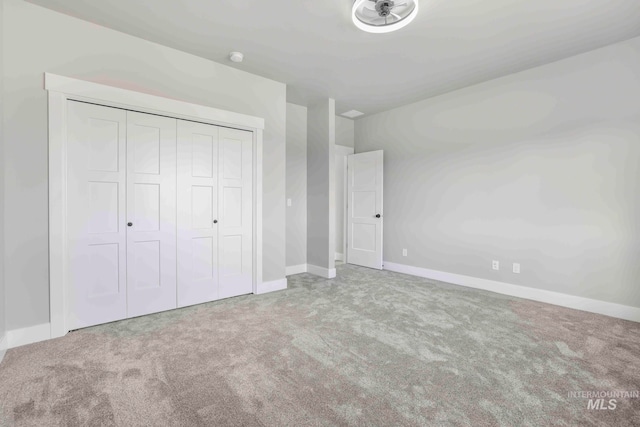 unfurnished bedroom with a closet and carpet floors