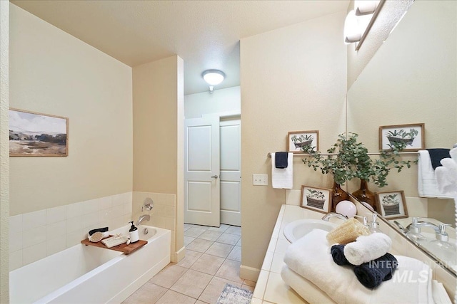 bathroom with a bathing tub, tile patterned floors, and vanity