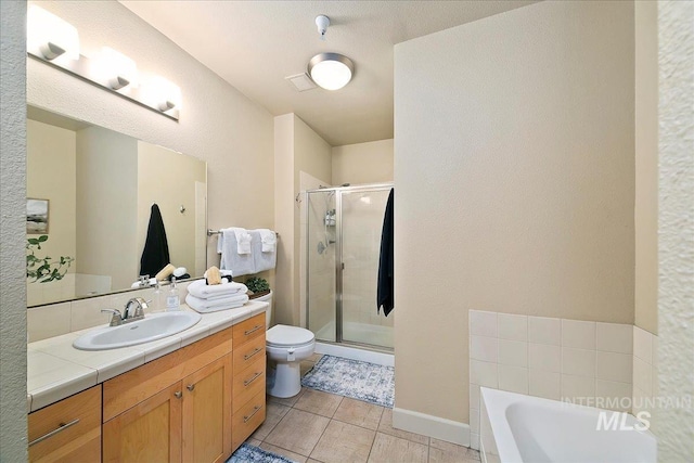 full bathroom with separate shower and tub, toilet, tile patterned floors, and vanity