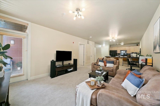 living room with a healthy amount of sunlight and light colored carpet