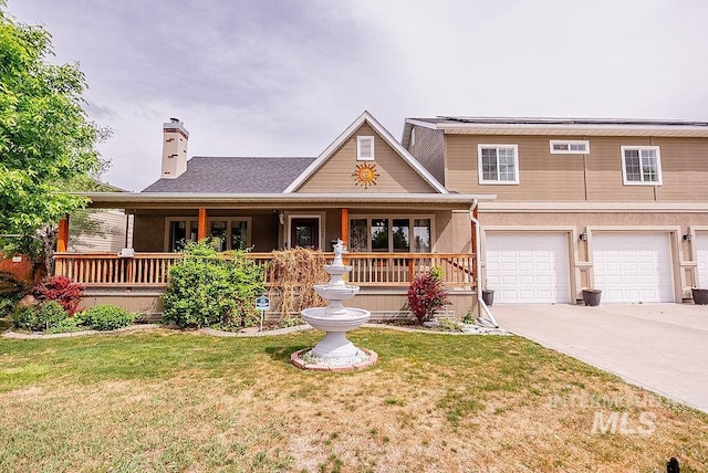 720 E Main St, Jerome, ID 83338 - view of front of home featuring concrete driveway, a front yard, a chimney, a porch, and a garage