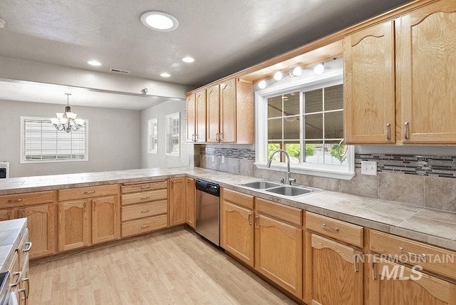 720 E Main St, Jerome, ID 83338 - kitchen with a sink, stainless steel dishwasher, light wood-style floors, backsplash, and a chandelier