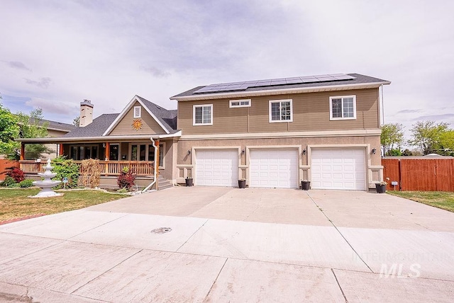 720 E Main St, Jerome, ID 83338 - view of front of home featuring covered porch, a garage, fence, and solar panels