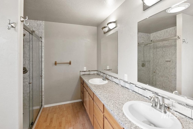 720 E Main St, Jerome, ID 83338 - full bathroom with a shower stall, wood finished floors, and double vanity
