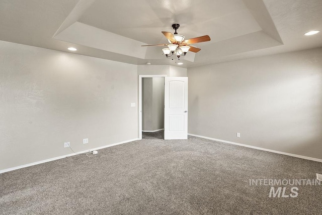 720 E Main St, Jerome, ID 83338 - spare room featuring a tray ceiling, recessed lighting, carpet, baseboards, and ceiling fan