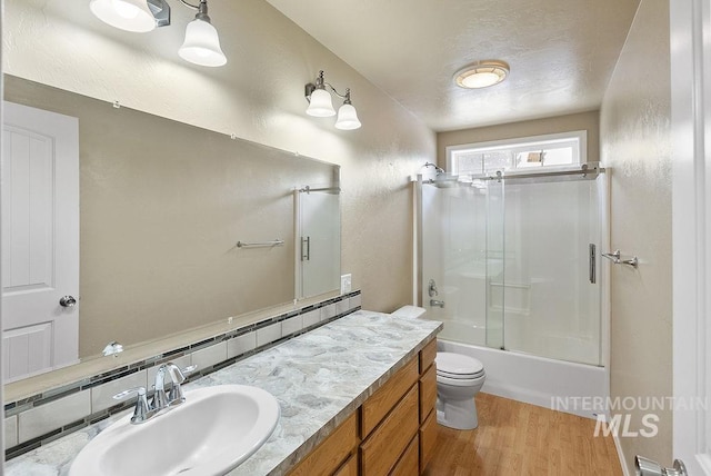 720 E Main St, Jerome, ID 83338 - full bathroom with wood finished floors, vanity, toilet, and enclosed tub / shower combo
