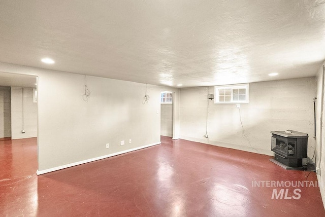720 E Main St, Jerome, ID 83338 - finished below grade area with a wood stove, baseboards, and recessed lighting