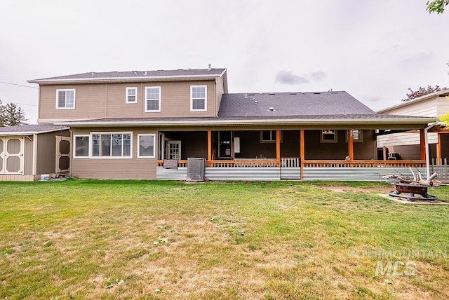 720 E Main St, Jerome, ID 83338 - rear view of property featuring a shed, an outdoor fire pit, a lawn, and an outbuilding