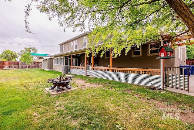 720 E Main St, Jerome, ID 83338 - back of property featuring an outdoor fire pit and stucco siding