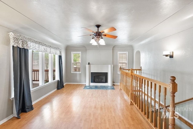 720 E Main St, Jerome, ID 83338 - living room featuring light wood-style floors, a ceiling fan, baseboards, and a fireplace with flush hearth