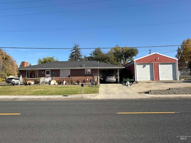 ranch-style house with a front lawn, an outbuilding, a garage, and a carport