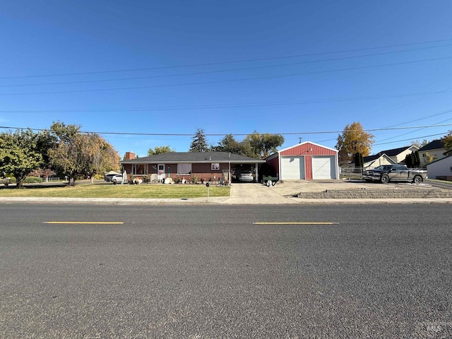 single story home with a garage and an outdoor structure