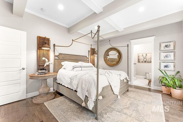 bedroom featuring crown molding, wood finished floors, ensuite bathroom, baseboards, and beam ceiling