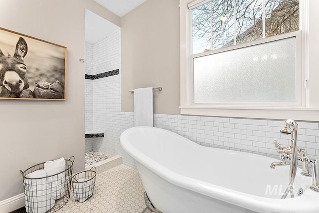 full bathroom featuring a soaking tub, tile walls, and tiled shower