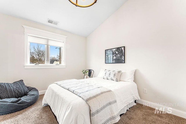bedroom featuring lofted ceiling, baseboards, visible vents, and carpet