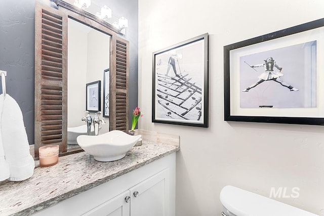 bathroom featuring toilet and vanity