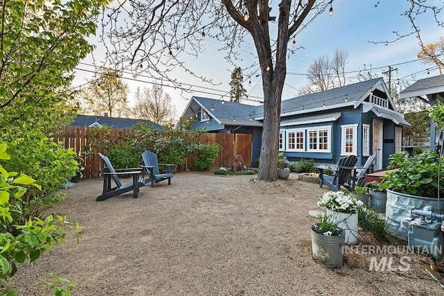 view of patio with an outbuilding and fence