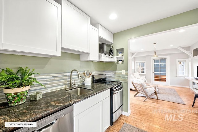 kitchen featuring white cabinets, stainless steel appliances, a sink, and recessed lighting