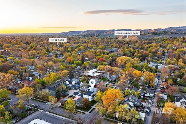 aerial view at dusk featuring a mountain view