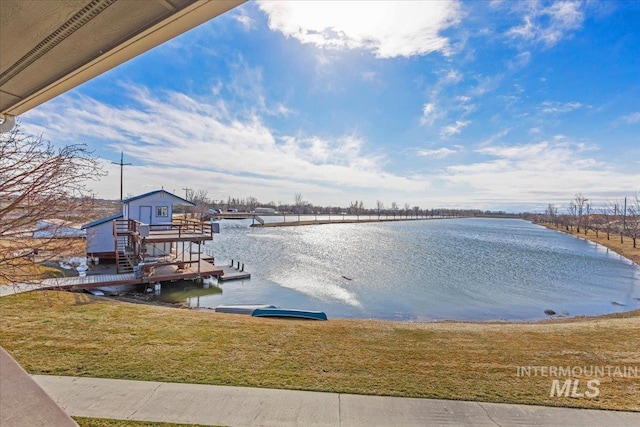 dock area featuring a yard and a water view