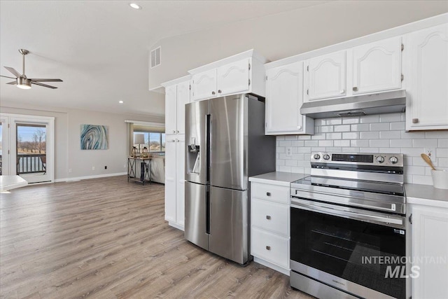 kitchen featuring under cabinet range hood, backsplash, appliances with stainless steel finishes, and ceiling fan