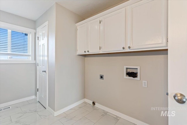 clothes washing area featuring baseboards, hookup for a washing machine, cabinet space, electric dryer hookup, and marble finish floor