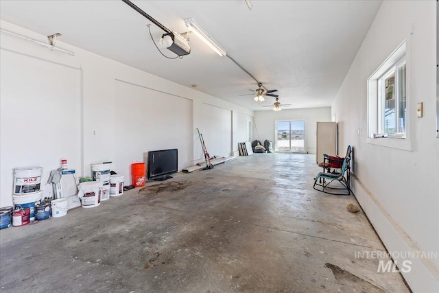 garage featuring a garage door opener and ceiling fan