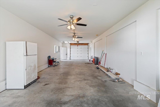 garage with freestanding refrigerator and ceiling fan