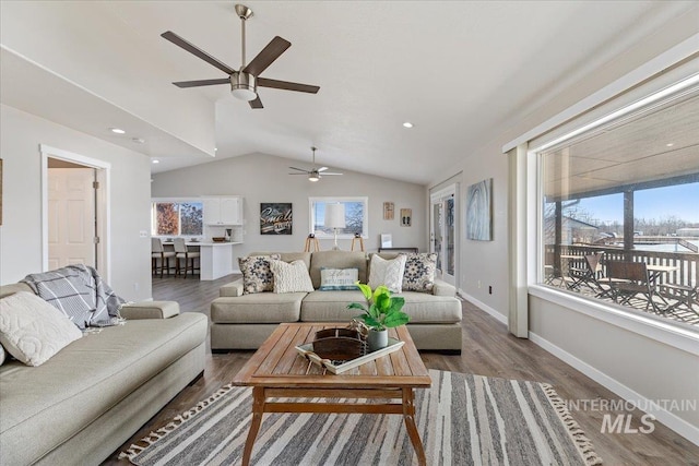 living area with baseboards, vaulted ceiling, recessed lighting, wood finished floors, and a ceiling fan