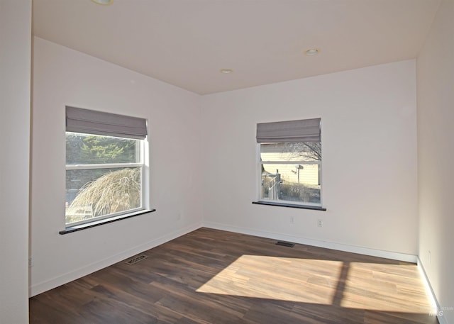 spare room featuring dark wood-type flooring