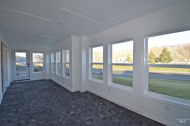 unfurnished sunroom featuring a wealth of natural light