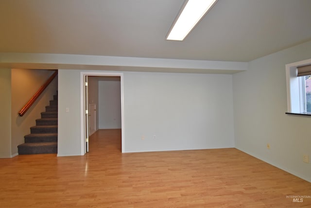 basement with light hardwood / wood-style floors