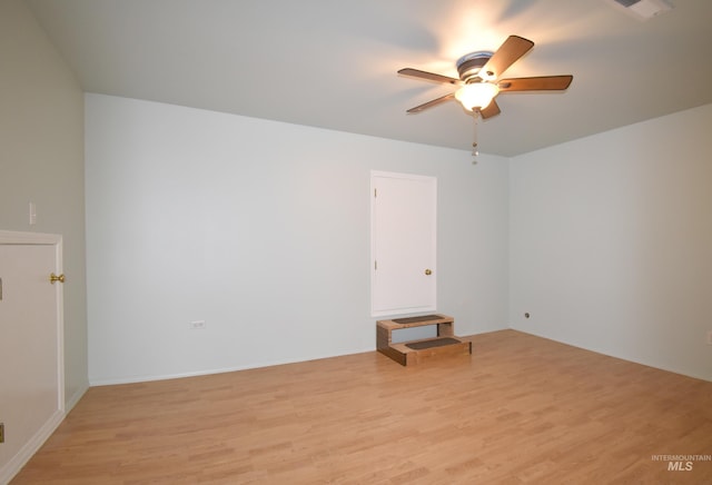 spare room featuring ceiling fan and light hardwood / wood-style flooring